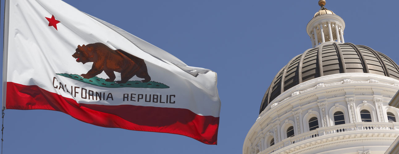 California flag waving in front of the State Capitol building in Sacramento