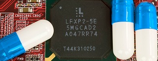 close up of three pills on top of circuit board
