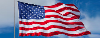 us flag blowing in the sky