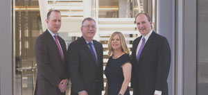 The American Lawyer Dealmakers four professionals posing in a building