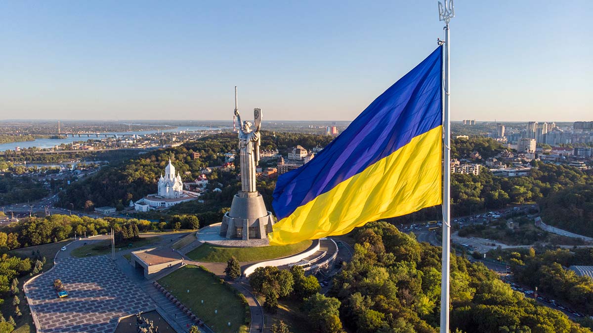 Ukraine flag in front of a monument